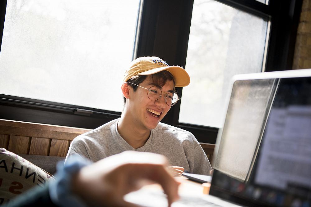 A student smiles while studying.